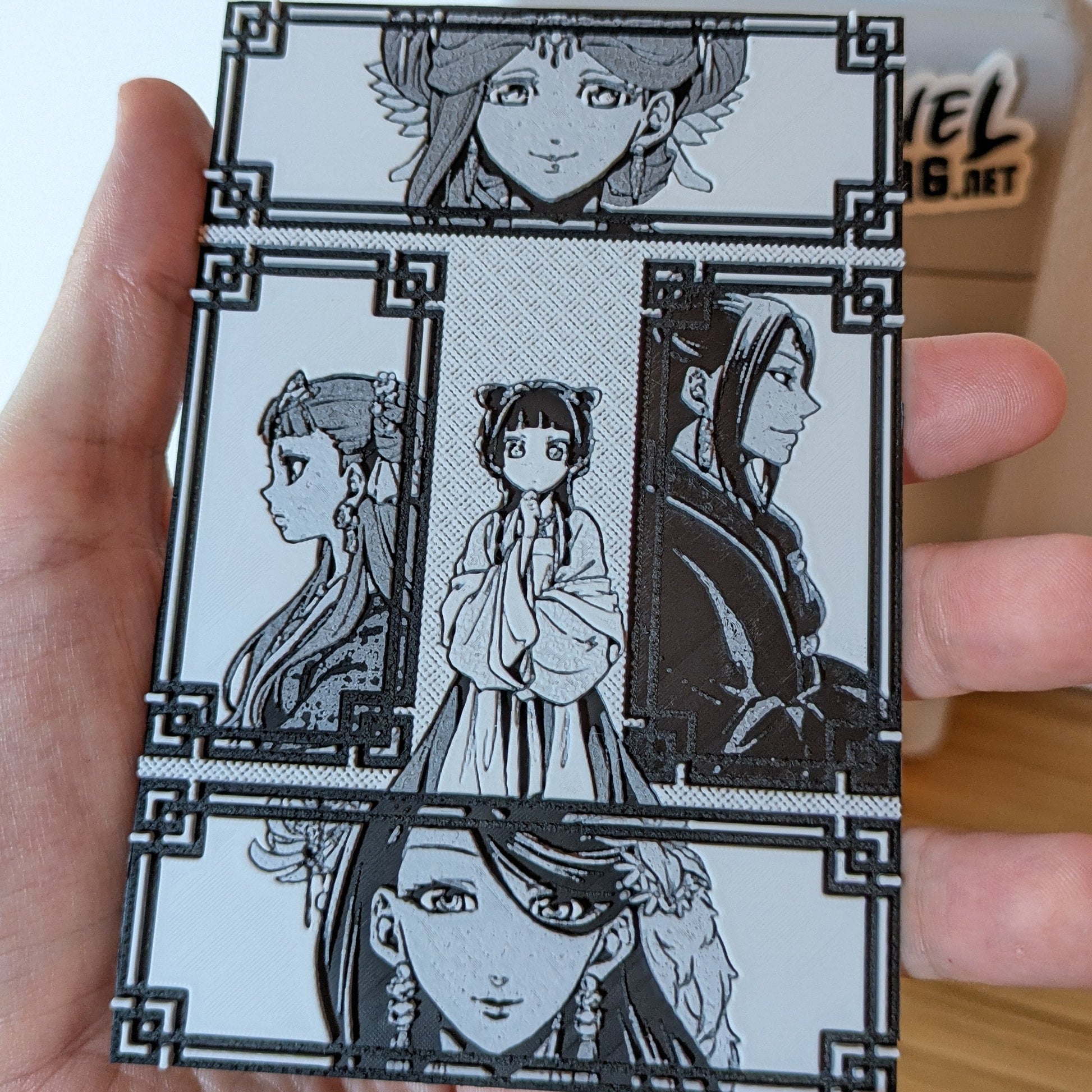 Close-up detail of Apothecary Diaries characters including Maomao in 3D printed magnet panel with ornate borders