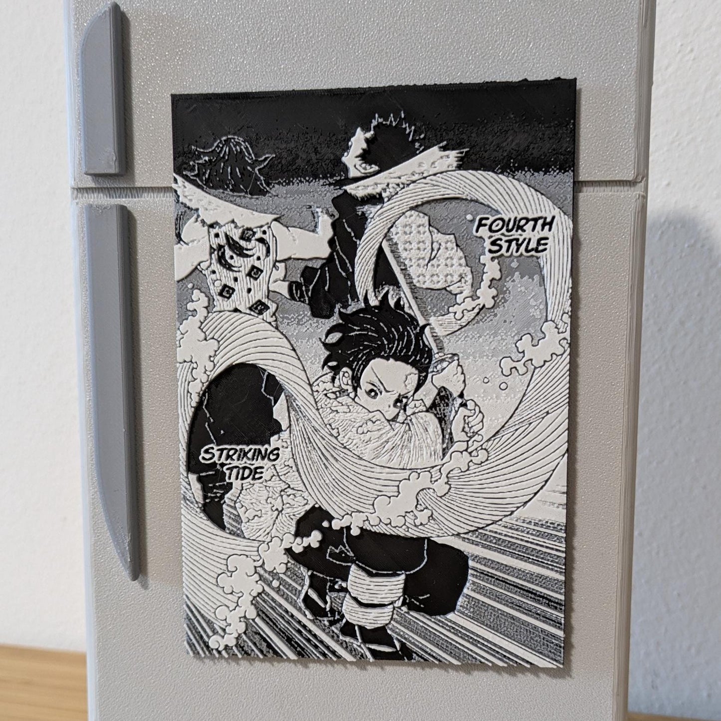 Close-up of handcrafted Demon Slayer Tanjiro magnet highlighting high-definition manga artwork and water breathing details